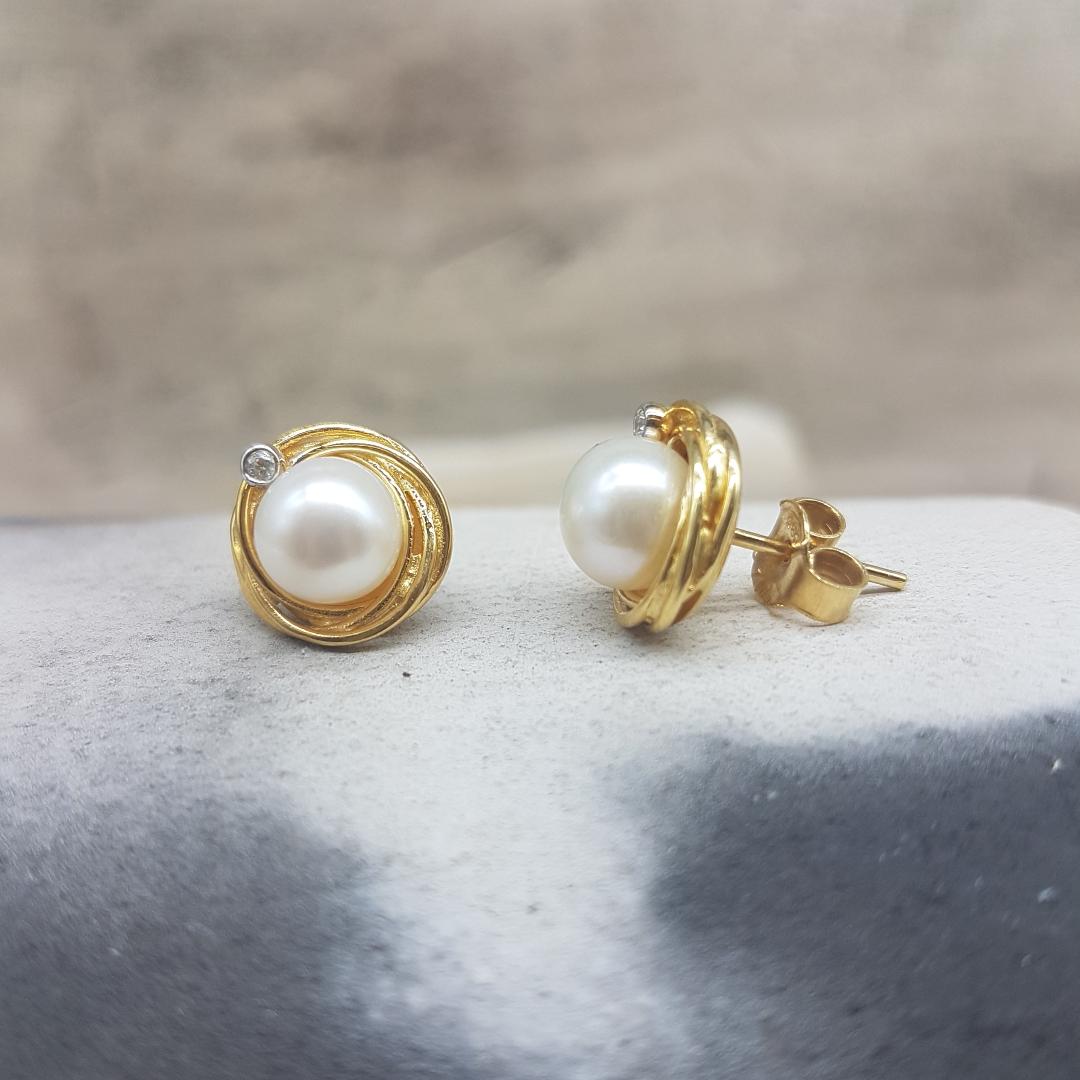 Womens handmade gold earrings K14 in the shape of a nest decorated with white natural pearls and white zircons.