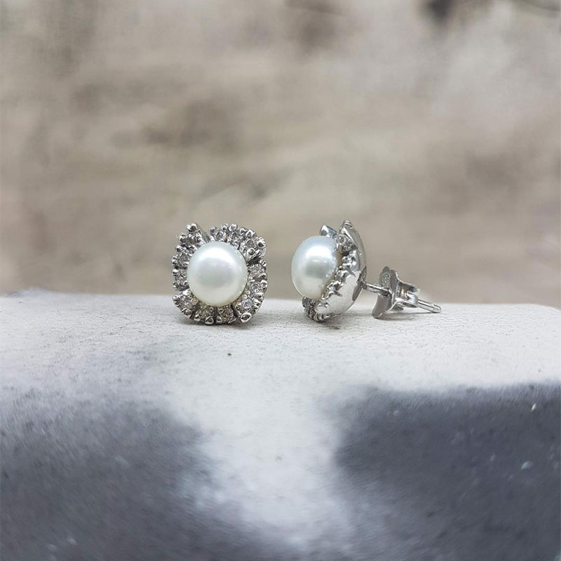 Womens white gold earrings K14 decorated with white pearls and white zircons.
