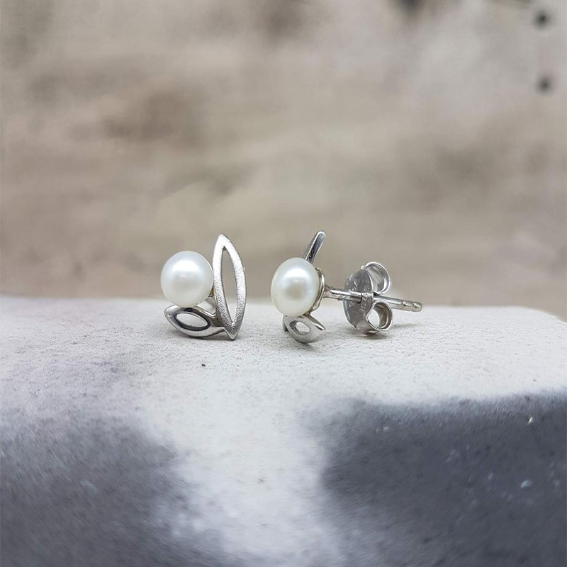 Womens white gold earrings K14 decorated with natural white pearls.