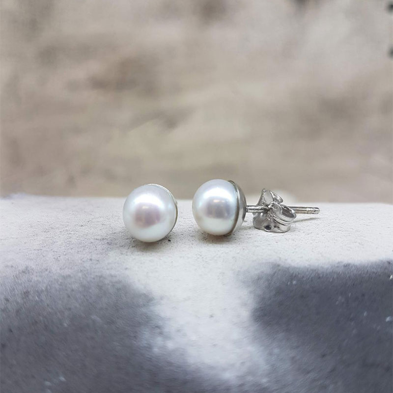 Womens handmade white gold earrings K14 decorated with round natural white pearls 6.8mm.