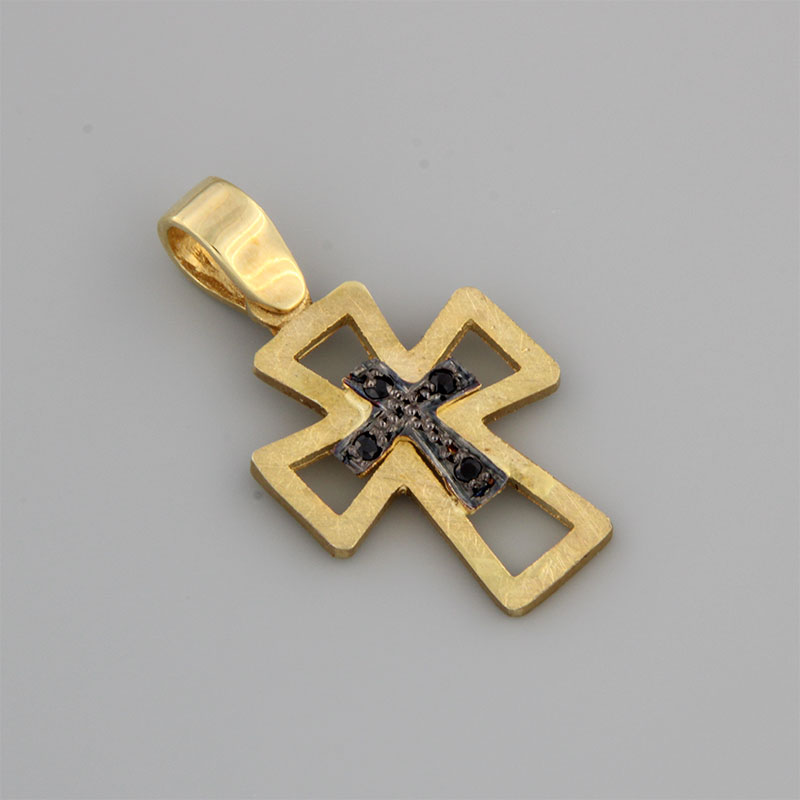 Womens handmade cross made of yellow gold K14 with special engraving treatment of black platinum and natural black Onyxes.