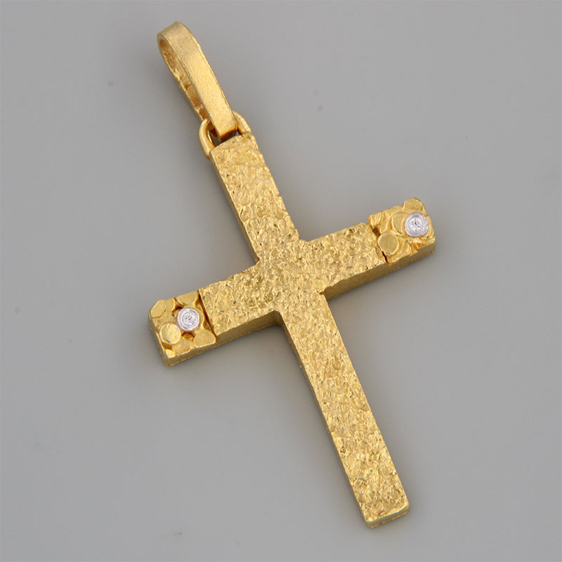 Womens handmade cross made of yellow gold K14 with special forging treatment and white zircons.