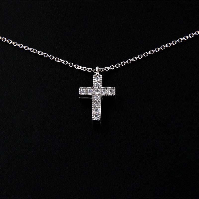 Womens small white gold cross with K9 two-sided chain decorated with white zircons on polished surfaces.