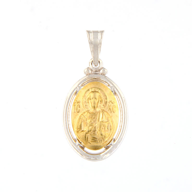 14 Carat bicolour pendant with the embossed figure of Christ.